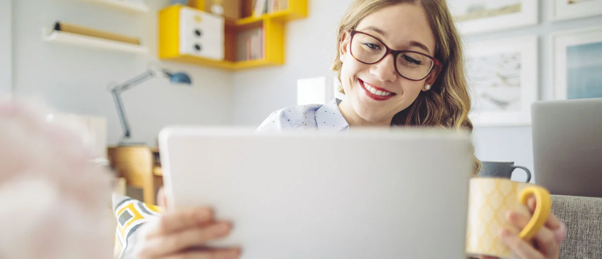 Woman smiling at laptop